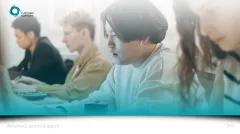 Four people looking at laptops